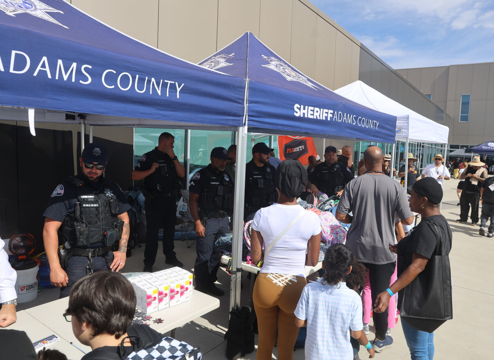 Members of the community visit the Adams County Sheriff's Office Tent at the Adams County Human Services Back to School Bash