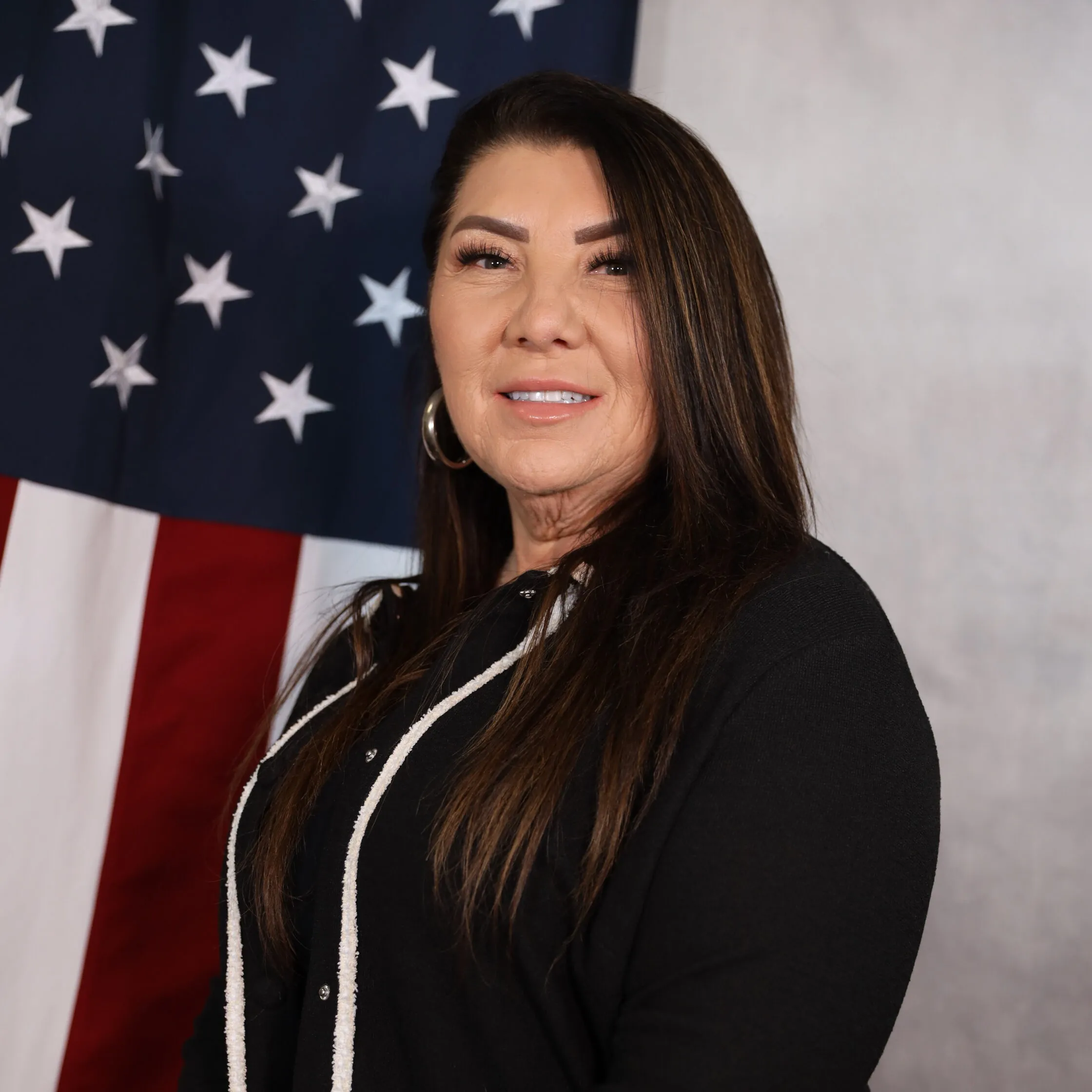 Garcia-Joann poses confidently in front of the American flag