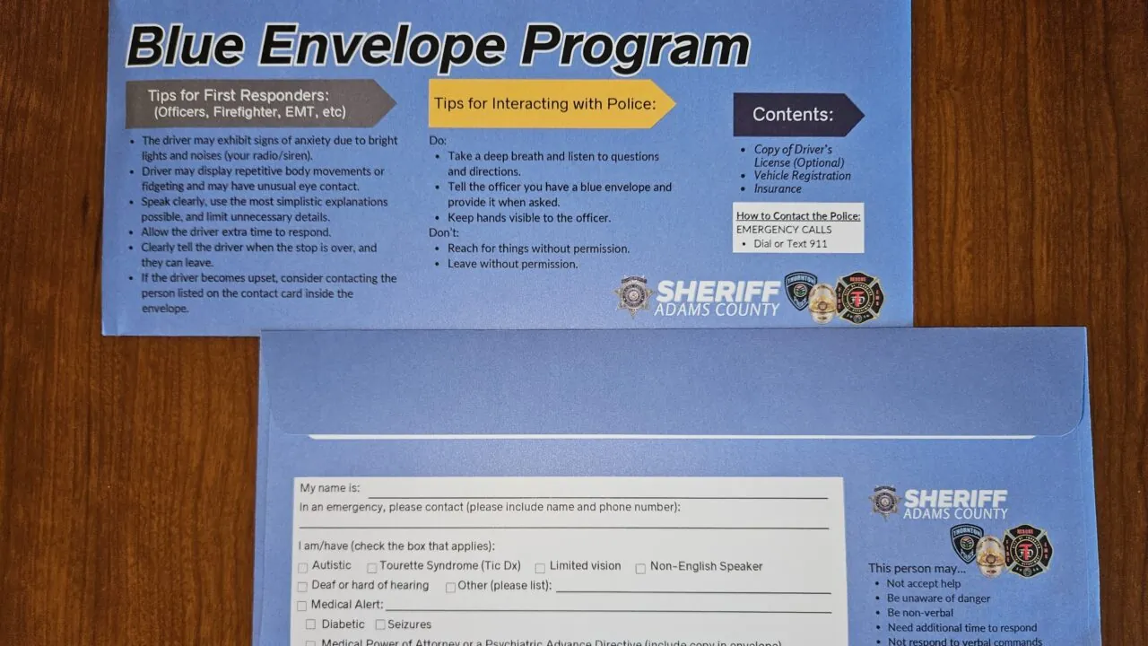 Blue Envelope Program materials on table, with tips for first responders and instructions for interacting with police from Sheriff Adams County.
