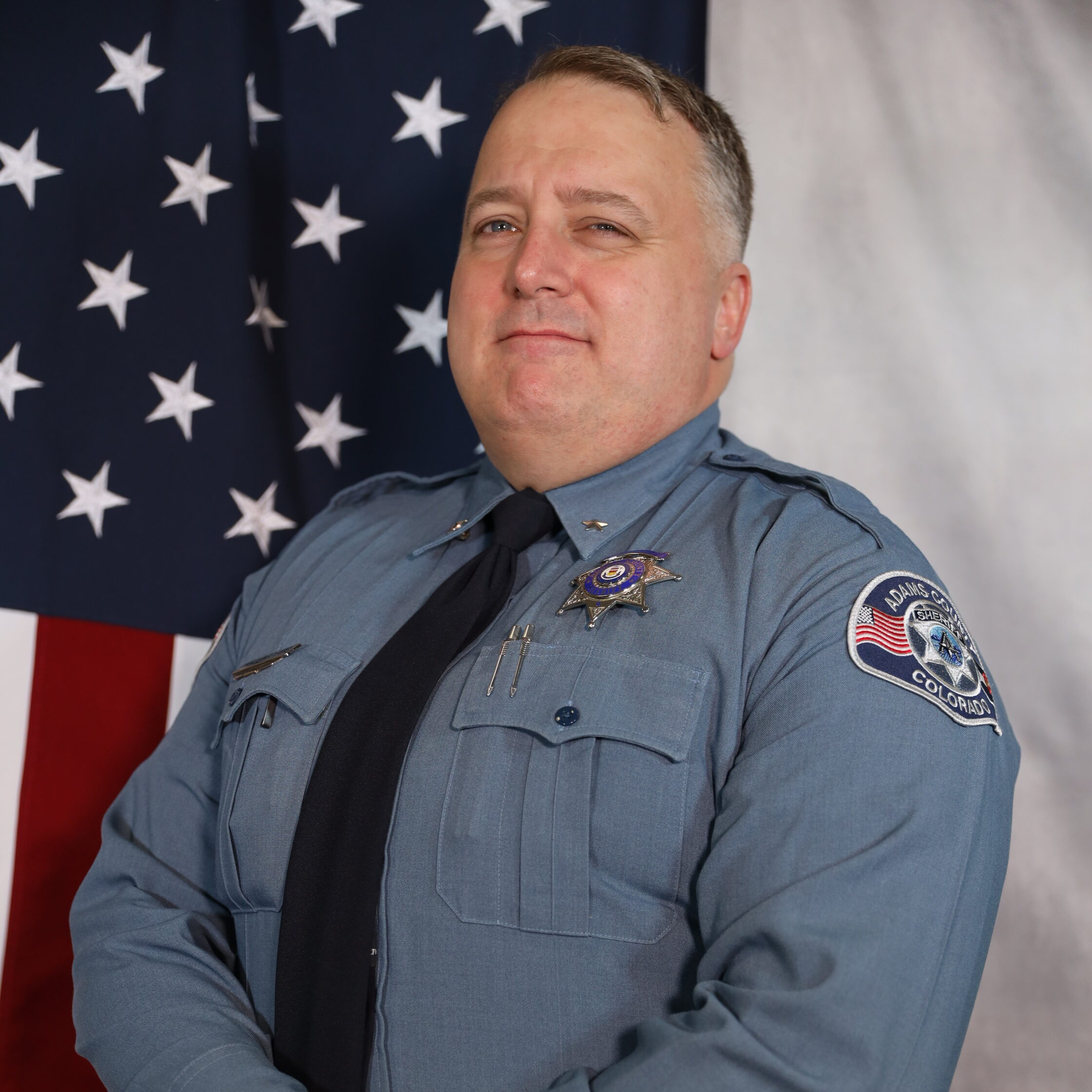 Timothy Jungclaus in uniform with American flag backdrop